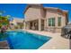 Sparkling swimming pool with covered patio, surrounded by green landscaping, and ideal for outdoor living at 22304 N 104Th Ln, Peoria, AZ 85383