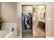 Spacious walk-in closet with mirrored doors leading to the main bath, offering ample storage at 22304 N 104Th Ln, Peoria, AZ 85383
