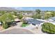 Aerial view of updated home features green lawn, mature trees, and proximity to nearby mountains at 2353 N 51St Pl, Phoenix, AZ 85008