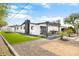 Charming backyard featuring artificial turf, gravel landscaping, and covered patio with outdoor seating and a built-in grill at 2353 N 51St Pl, Phoenix, AZ 85008