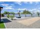 Large backyard with gravel, artificial grass, and an outdoor fire pit at 2353 N 51St Pl, Phoenix, AZ 85008