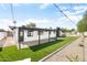 Rear exterior showcasing a covered patio, artificial turf, gravel accents, and the home's modern, clean design at 2353 N 51St Pl, Phoenix, AZ 85008