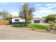 An exterior view of a home showcasing desert landscaping, a modern design, and contrasted by black and white siding at 2353 N 51St Pl, Phoenix, AZ 85008