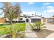 Beautiful home exterior featuring lush landscaping, stone walkway, and a modern design with a black garage door at 2353 N 51St Pl, Phoenix, AZ 85008