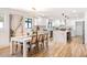 Open floor plan showcases kitchen with a waterfall island, stainless appliances, and a dining area with a chandelier at 2353 N 51St Pl, Phoenix, AZ 85008