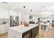 Open concept living space showcasing the kitchen, dining, and living areas with views to the backyard at 2353 N 51St Pl, Phoenix, AZ 85008