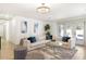Bright living room with an L-shaped couch, modern lighting, and neutral color palette with accent pillows at 2353 N 51St Pl, Phoenix, AZ 85008