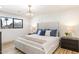 Well-lit main bedroom featuring a padded headboard, modern wall decor, bedside tables and a window view at 2353 N 51St Pl, Phoenix, AZ 85008