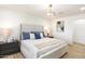 Beautiful main bedroom features a padded headboard, wood look tile flooring, and modern ceiling light at 2353 N 51St Pl, Phoenix, AZ 85008