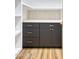 Walk-in pantry features drawers, cabinets, open shelves and quartz countertops with modern tile backsplash at 2353 N 51St Pl, Phoenix, AZ 85008