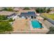 Aerial shot of a home with a pool, solar panels, and a dirt lot ready for landscaping at 24350 S 208Th Pl, Queen Creek, AZ 85142