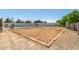 Wide angle view of a backyard showing a dirt lot, wooden trim, and a swimming pool at 24350 S 208Th Pl, Queen Creek, AZ 85142
