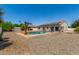 An angle view of the backyard, featuring a pool, seating and solar panels on the house at 24350 S 208Th Pl, Queen Creek, AZ 85142