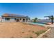The property features a backyard with a pool and a dirt lot ready for landscaping at 24350 S 208Th Pl, Queen Creek, AZ 85142