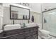 Bathroom featuring dual sinks, stylish vanity and a shower with glass door at 24350 S 208Th Pl, Queen Creek, AZ 85142