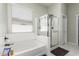 Well-lit bathroom boasting separate shower and tub, enhancing relaxation and convenience at 24350 S 208Th Pl, Queen Creek, AZ 85142