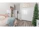 Cozy bedroom features wood-look floors, creating a warm, inviting atmosphere at 24350 S 208Th Pl, Queen Creek, AZ 85142