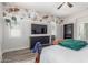 Inviting bedroom featuring stylish wallpaper, mounted television, and two bright, airy windows with modern blinds at 24350 S 208Th Pl, Queen Creek, AZ 85142