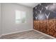Bedroom features stylish wall decor, wood-look flooring, and natural light from a window at 24350 S 208Th Pl, Queen Creek, AZ 85142