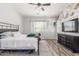Bedroom featuring a metal frame bed, neutral walls, sleek ceiling fan and two light-filled windows at 24350 S 208Th Pl, Queen Creek, AZ 85142