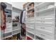 This spacious closet is fitted with custom organizers, offering neat storage solutions for clothes and accessories at 24350 S 208Th Pl, Queen Creek, AZ 85142