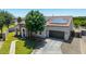 Exterior shot of a well landscaped home with a long driveway and solar panels on the roof at 24350 S 208Th Pl, Queen Creek, AZ 85142