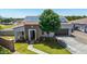 Exterior shot of the home, featuring a well maintained lawn, solar panels, and stone accents at 24350 S 208Th Pl, Queen Creek, AZ 85142
