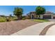 Beautiful single-story residence with stone detail, easy care xeriscape, and a green lawn at 24350 S 208Th Pl, Queen Creek, AZ 85142