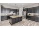 Contemporary kitchen featuring dark cabinets, stainless appliances, and an island at 24350 S 208Th Pl, Queen Creek, AZ 85142
