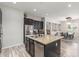 Well-lit kitchen featuring an island with granite countertops, stainless steel appliances, and ample cabinetry at 24350 S 208Th Pl, Queen Creek, AZ 85142