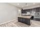 Open-concept kitchen featuring dark cabinetry and a center island with granite countertops at 24350 S 208Th Pl, Queen Creek, AZ 85142