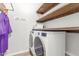 Laundry area with modern washer and dryer, rustic shelves and ample storage space at 24350 S 208Th Pl, Queen Creek, AZ 85142