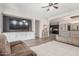 Open-concept living room with built-in media center, ceiling fan, and gray sofa at 24350 S 208Th Pl, Queen Creek, AZ 85142