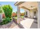 Back patio has ceiling fan, comfortable seating, lush landscaping, and privacy wall at 2611 S Quaintance St, Gilbert, AZ 85295