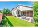 Backyard featuring artificial turf, grill, outdoor seating, and covered patio at 2611 S Quaintance St, Gilbert, AZ 85295