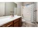 Bathroom features vanity sink, toilet, shower and tub, and light gray walls at 2611 S Quaintance St, Gilbert, AZ 85295