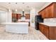 Bright kitchen with stone backsplash, stainless steel appliances, and light countertops contrasting with dark cabinets at 2611 S Quaintance St, Gilbert, AZ 85295