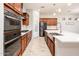 Modern kitchen boasting stainless steel appliances, white countertops, dark cabinets, and wood-look tile flooring at 2611 S Quaintance St, Gilbert, AZ 85295