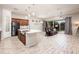 Open concept living room featuring tile flooring, modern lighting, and sliding glass doors to the backyard at 2611 S Quaintance St, Gilbert, AZ 85295