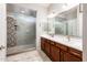 Main bathroom with double sinks and a tiled shower at 2611 S Quaintance St, Gilbert, AZ 85295