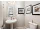 Powder Room showcases pedestal sink, decorative mirror, and light gray walls at 2611 S Quaintance St, Gilbert, AZ 85295