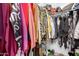 Walk in closet full of clothes, bags, and shoes at 2650 W Union Hills Dr # 98, Phoenix, AZ 85027