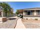 Exterior shot highlighting the home's covered patio and low-maintenance desert landscape at 2650 W Union Hills Dr # 98, Phoenix, AZ 85027