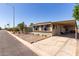 A well-maintained home featuring a covered carport, desert landscaping and paved driveway at 2650 W Union Hills Dr # 98, Phoenix, AZ 85027