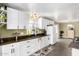 Functional kitchen with ample counter space, white cabinets, and stainless steel sink at 2650 W Union Hills Dr # 98, Phoenix, AZ 85027