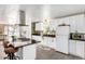 Well-lit kitchen with white cabinetry, dark countertops, and a breakfast bar at 2650 W Union Hills Dr # 98, Phoenix, AZ 85027