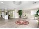 Open-concept living space with modern lighting, wood-look floors, and breakfast bar at 2650 W Union Hills Dr # 98, Phoenix, AZ 85027