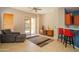 Living room showcases tile floors, a gray sofa, wooden console, and access to the backyard pool area at 26633 N 41St Way, Cave Creek, AZ 85331