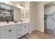 Modern bathroom with double vanity, matte black fixtures and shower with gray tiled walls at 28065 N 171St Dr, Surprise, AZ 85387