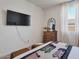 Bright bedroom with a flat screen television, dresser with an accent mirror, and seating bench at 28065 N 171St Dr, Surprise, AZ 85387